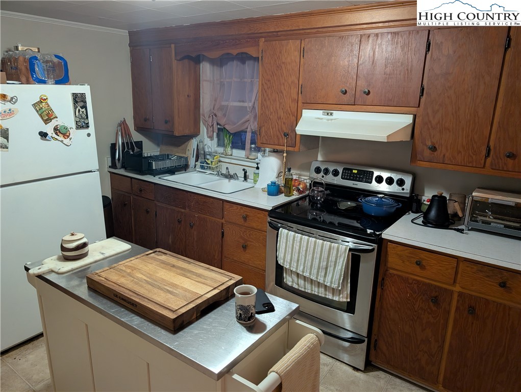 1630 Highway 194 Boone, NC 28607 - Photo 5 of 12 a kitchen with a sink a stove and a refrigerator