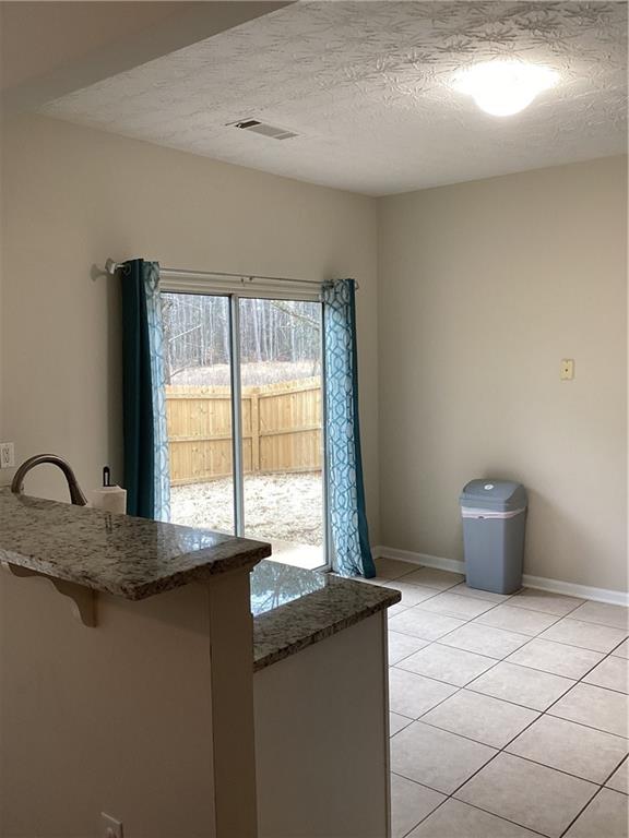 2546 Tullamore Circle Snellville, GA 30039 - Photo 12 of 35 a kitchen with granite countertop a sink and a window