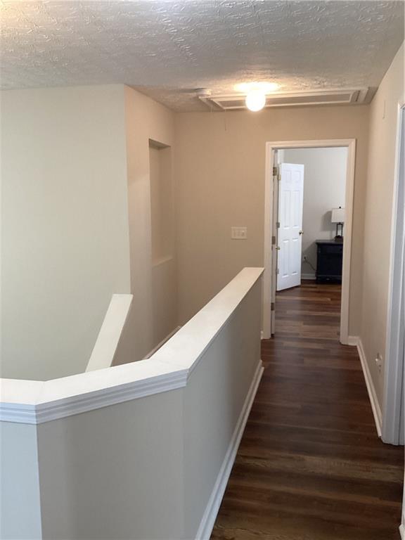 2546 Tullamore Circle Snellville, GA 30039 - Photo 20 of 35 a hallway with wooden floor and staircase