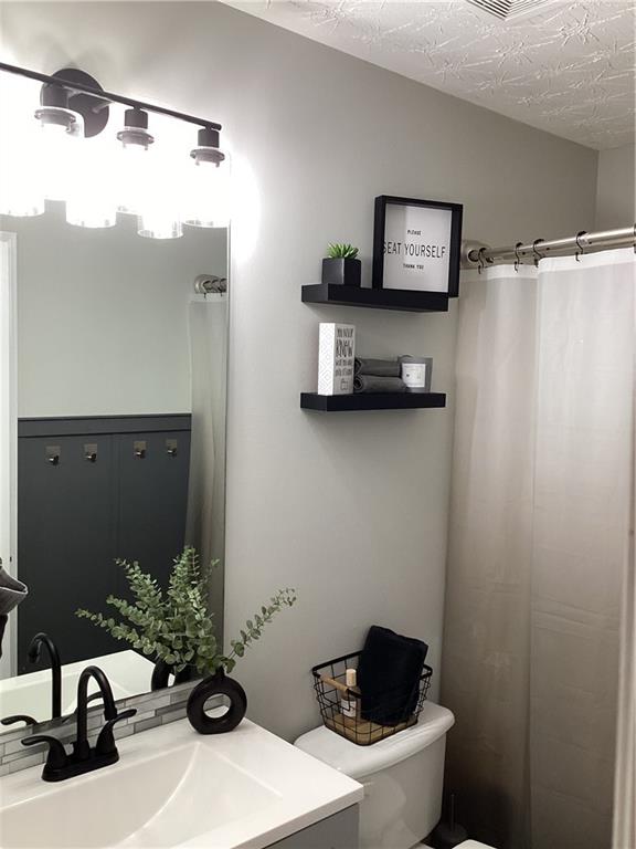 2546 Tullamore Circle Snellville, GA 30039 - Photo 22 of 35 a bathroom with a toilet and a sink