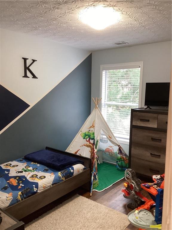 2546 Tullamore Circle Snellville, GA 30039 - Photo 24 of 35 a bedroom with furniture and a window