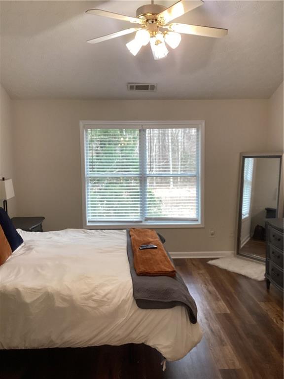 2546 Tullamore Circle Snellville, GA 30039 - Photo 26 of 35 a bedroom with a bed and a chandelier