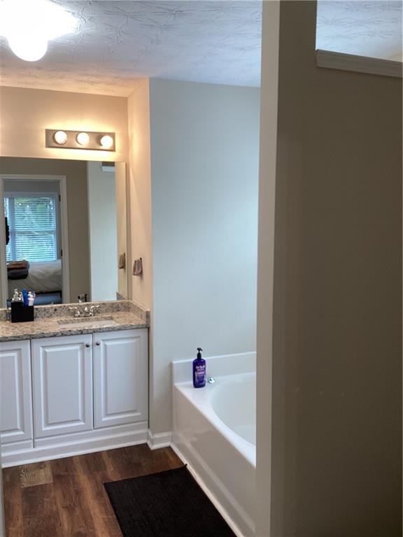 2546 Tullamore Circle Snellville, GA 30039 - Photo 27 of 35 a bathroom with a tub sink and mirror