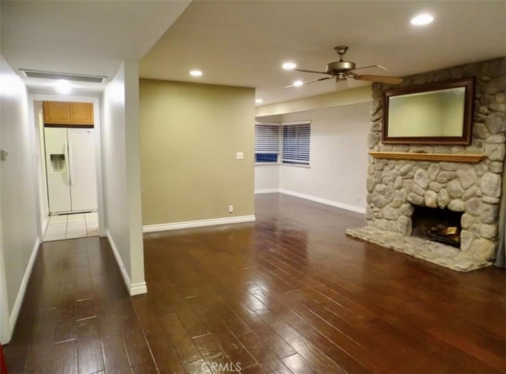 22654 La Rochelle Drive Saugus, CA 91350 - Photo 3 of 13 a view of a livingroom with a fireplace a chandelier and wooden floor