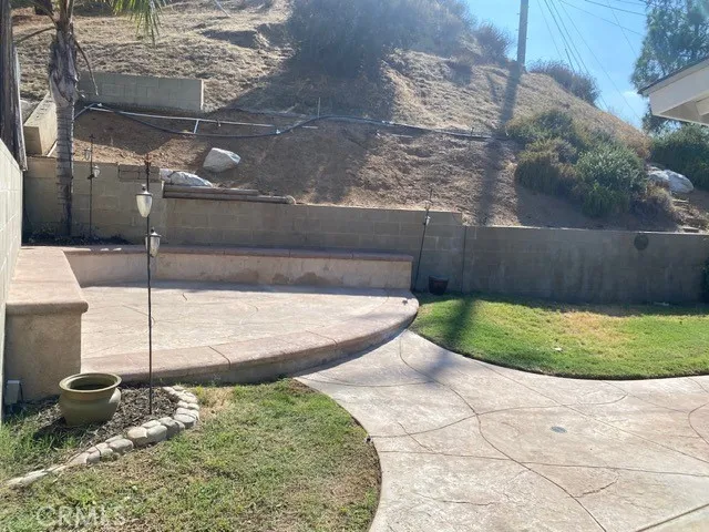 a view of a backyard with sitting area