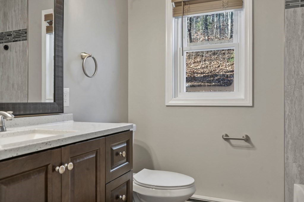 114 Upper Palmer Road Monson, MA 01057 - Photo 13 of 34 a bathroom with a granite countertop toilet sink and mirror