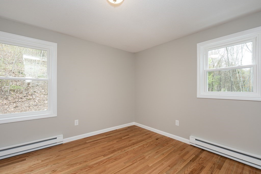 114 Upper Palmer Road Monson, MA 01057 - Photo 20 of 34 a view of an empty room with wooden floor and a window