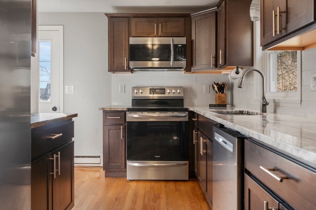 114 Upper Palmer Road Monson, MA 01057 - Photo 5 of 34 a kitchen with a stove and a microwave