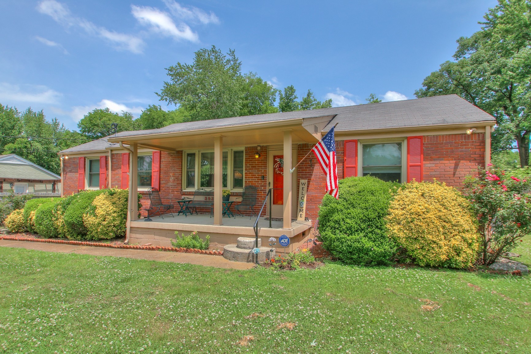 a view of a house with a yard porch and sitting area