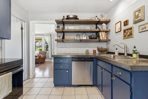 a kitchen with stainless steel appliances granite countertop a stove and a refrigerator