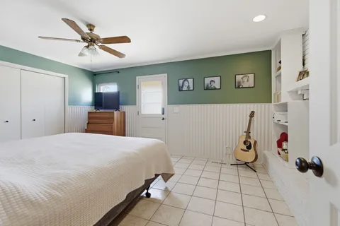 a bedroom with a bed and a ceiling fan