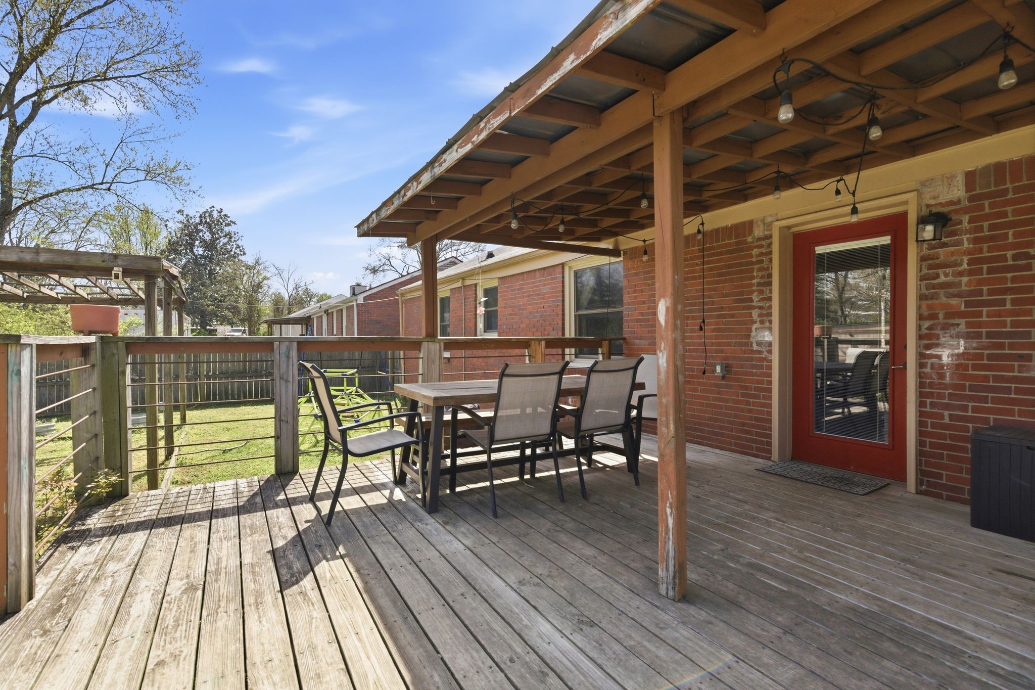 3938 East Ridge Drive Nashville, TN 37211 - Photo 28 of 32 a view of a roof deck with table and chairs and wooden floor