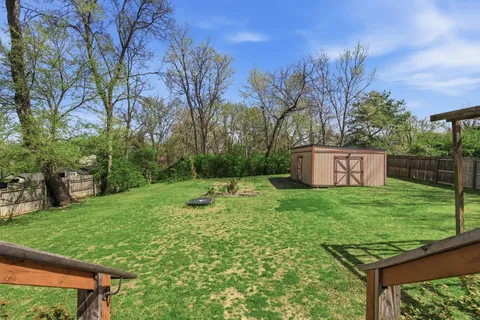 a view of a house with backyard and a garden