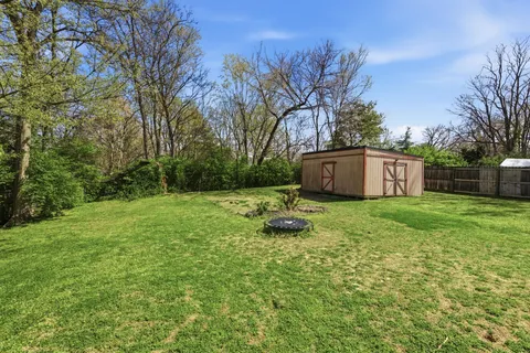 a view of a yard with a house in the background