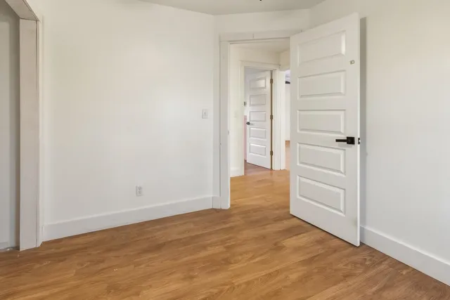 an empty room with wooden floor