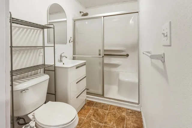 a white toilet sitting next to a bathroom sink