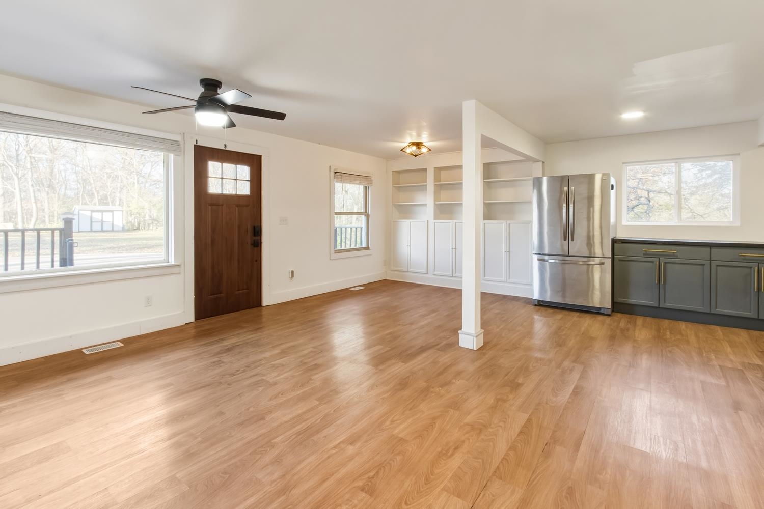 506 Eells Avenue Dixon, IL 61021 - Photo 3 of 19 an empty room with wooden floor cabinet and windows