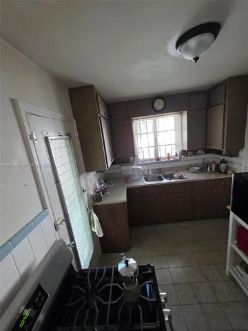a kitchen with a table chairs and a stove