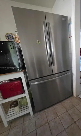 a kitchen with stainless steel appliances granite countertop a refrigerator and a stove