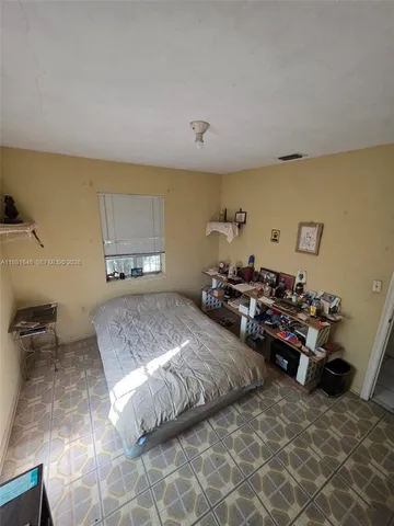a bedroom with bed and a couch