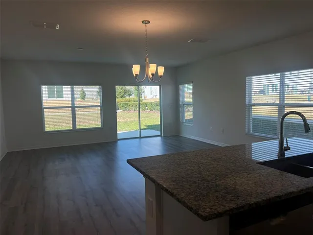 a view of a kitchen and wooden floor