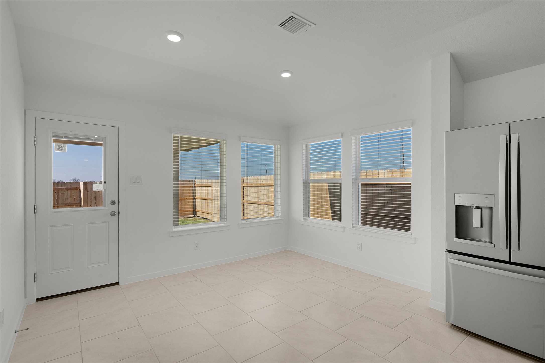 13832 Scarlett Song Drive Elgin, TX 78621 - Photo 9 of 26 Unfurnished dining area featuring recessed lighting and light tile patterned floors