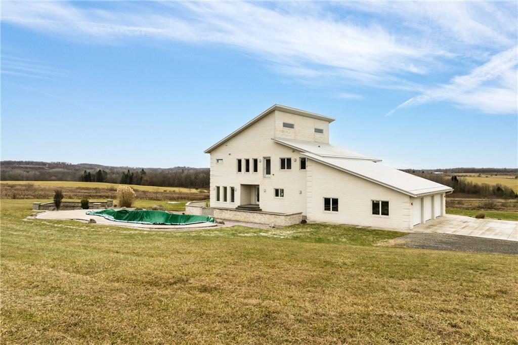 427 Jones Road Harrisville, PA 16038 - Photo 27 of 29 a big white house with a big yard and large trees