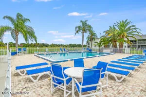 a view of a garden with a house in the background
