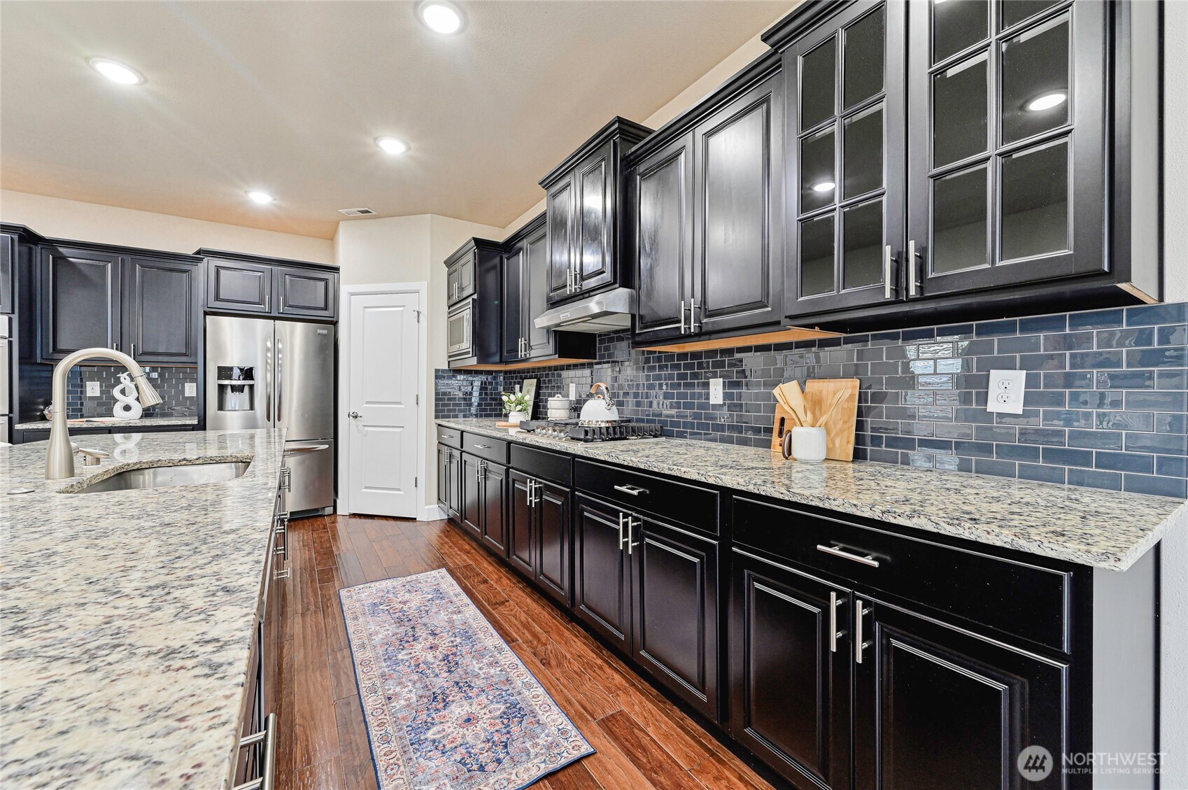 17312 40th Avenue Southeast Bothell, WA 98012 - Photo 11 of 34 a kitchen with stainless steel appliances granite countertop a stove a sink and a microwave