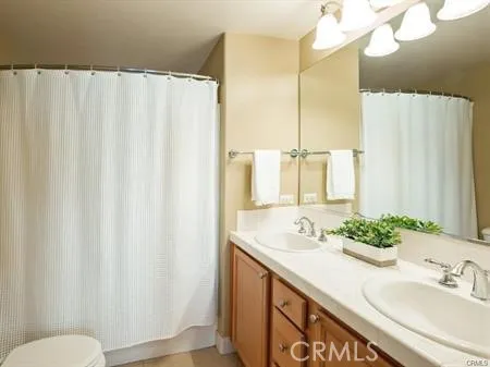 a bathroom with a double vanity sink and a mirror