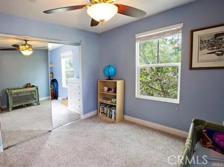a view of a livingroom with furniture and a window