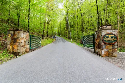 a view of a street with a big yard
