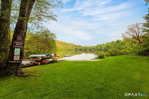 a view of yard with swimming pool and green space