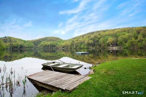 a view of a lake with furniture and a lake view