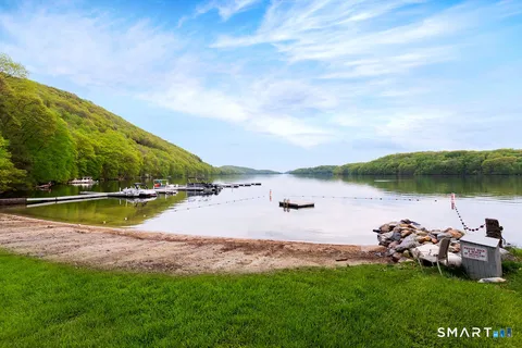 a view of a lake with houses in the back