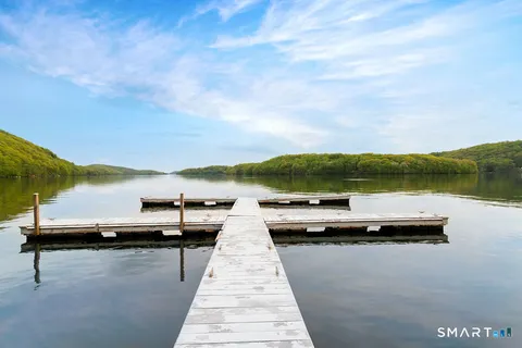 a view of swimming pool with outdoor seating and lake
