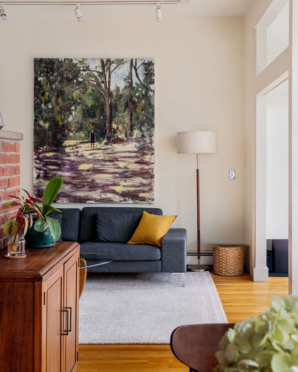 61 Dana Street, Unit 4 Cambridge, MA 02138 - Photo 11 of 25 a living room with furniture a lamp and a potted plant