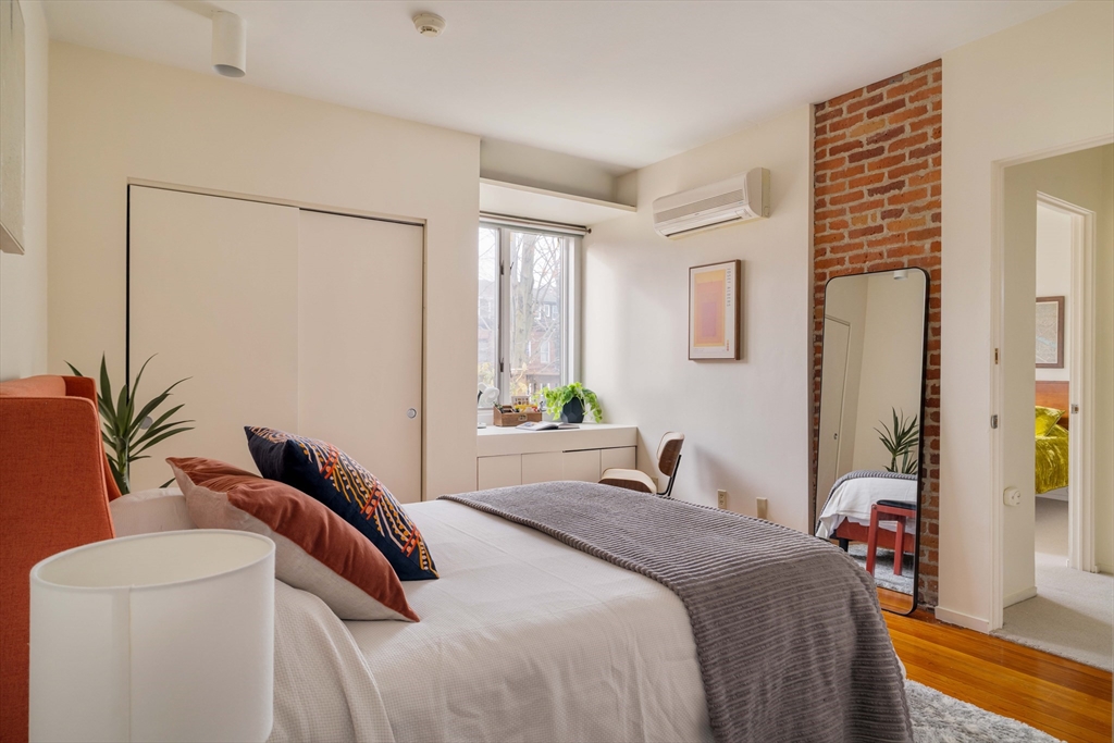 61 Dana Street, Unit 4 Cambridge, MA 02138 - Photo 18 of 25 a bedroom with a bed and a potted plant
