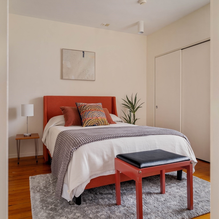 61 Dana Street, Unit 4 Cambridge, MA 02138 - Photo 19 of 25 a bedroom with a bed and a couch