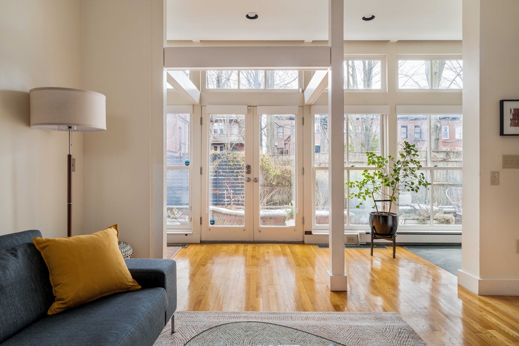 61 Dana Street, Unit 4 Cambridge, MA 02138 - Photo 2 of 25 a living room with furniture and a large window