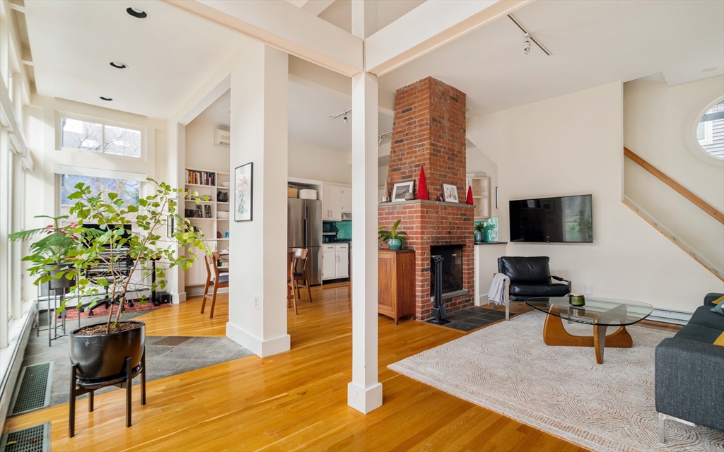 61 Dana Street, Unit 4 Cambridge, MA 02138 - Photo 3 of 25 a living room with furniture and a flat screen tv