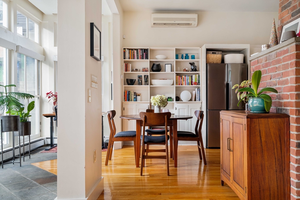 61 Dana Street, Unit 4 Cambridge, MA 02138 - Photo 4 of 25 a view of a dining room with furniture and wooden floor
