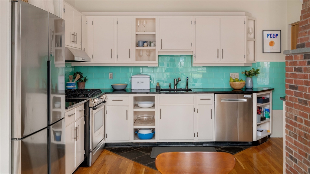 61 Dana Street, Unit 4 Cambridge, MA 02138 - Photo 9 of 25 a kitchen with stainless steel appliances white cabinets and a refrigerator