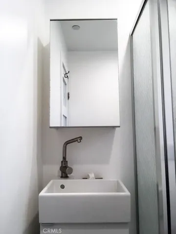 a bathroom with a sink and mirror