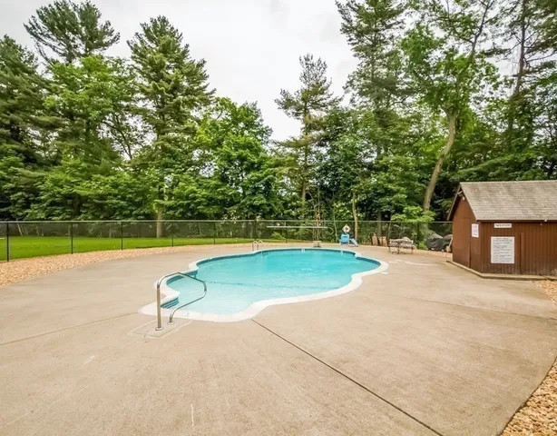 a view of a swimming pool and a yard