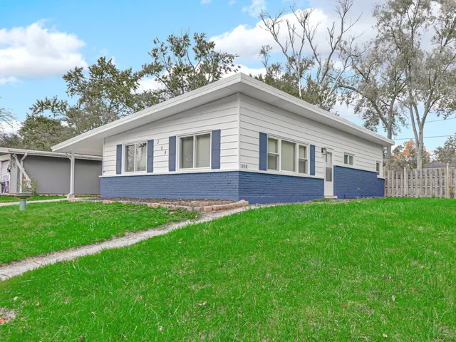 a view of an house with backyard space and garden