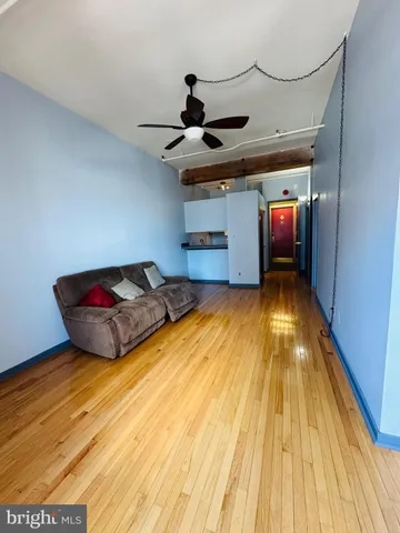 a living room with hardwood floor and a window