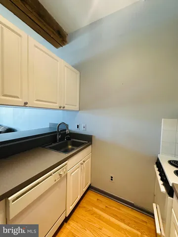 a kitchen with a refrigerator sink and cabinets