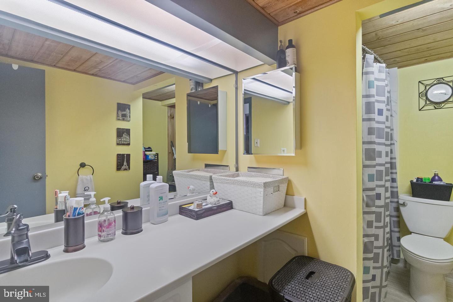 1010 Race Street, Unit 5D Philadelphia, PA 19107 - Photo 5 of 25 a bathroom with a granite countertop sink and a mirror