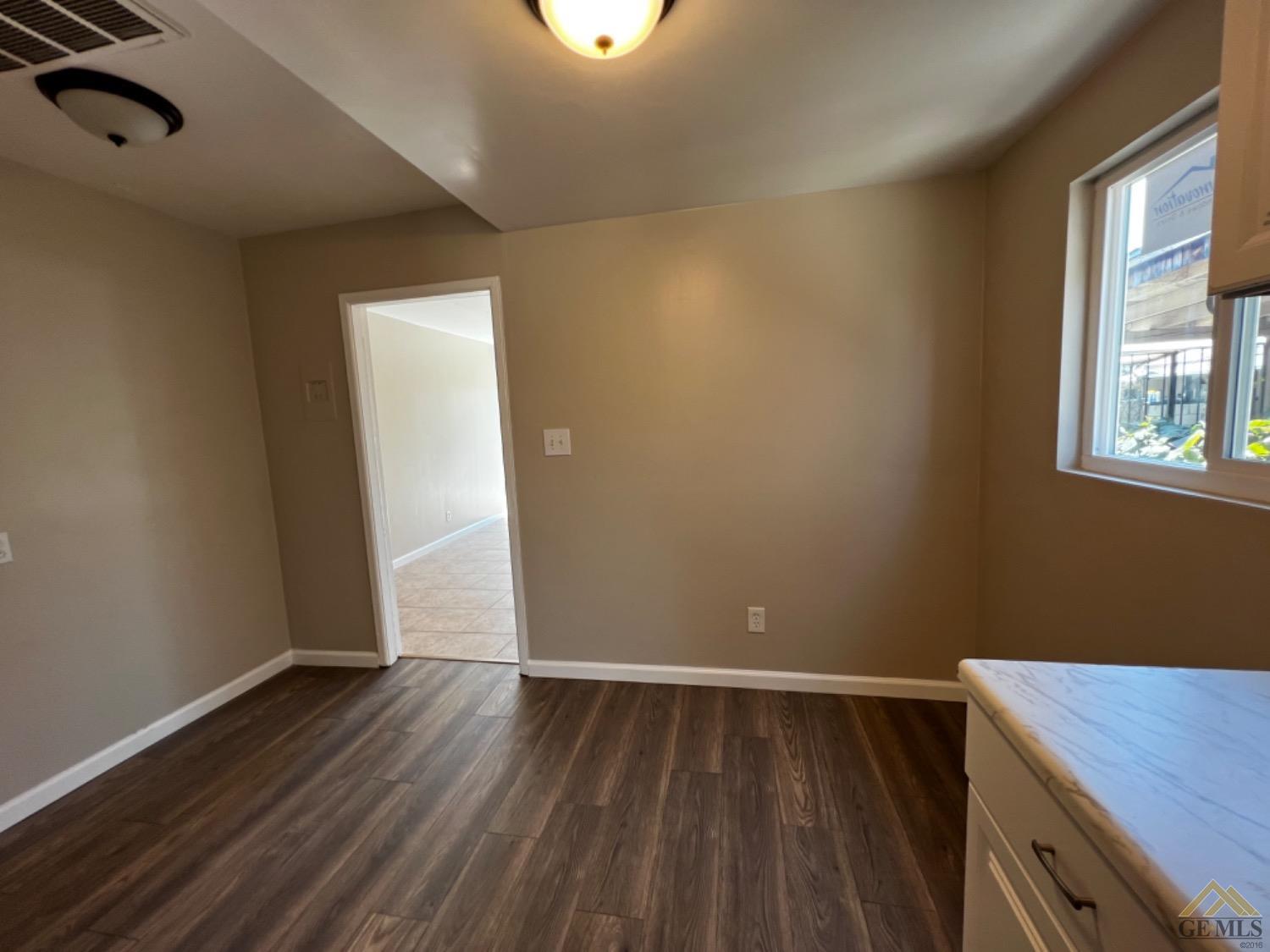 Undisclosed Address Bakersfield, CA 93304 - Photo 11 of 18 a view of a room with wooden floor and window